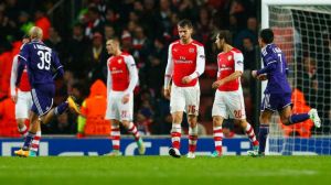 Arsenal hang their heads in frustration after struggling to keep Anderlecht  from ruining their lead.